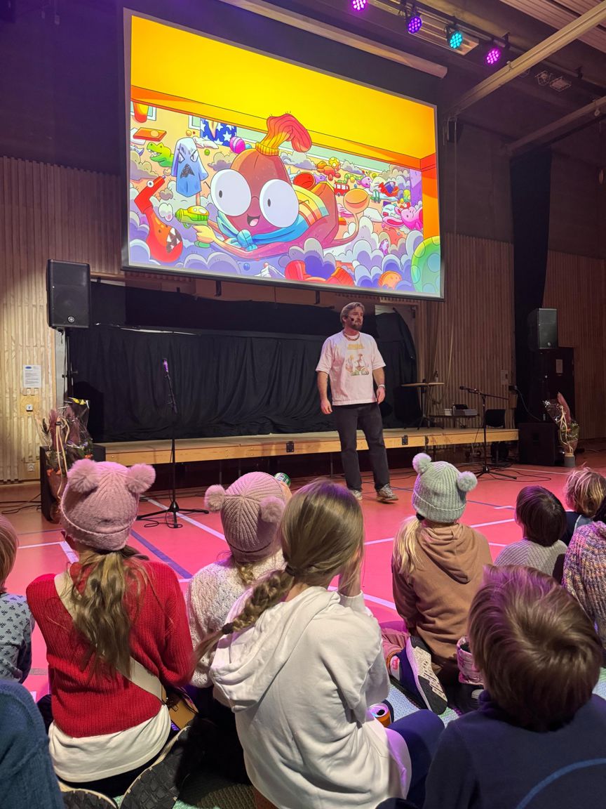 Foto: Guro En person som står foran en gruppe mennesker som sitter på gulvet